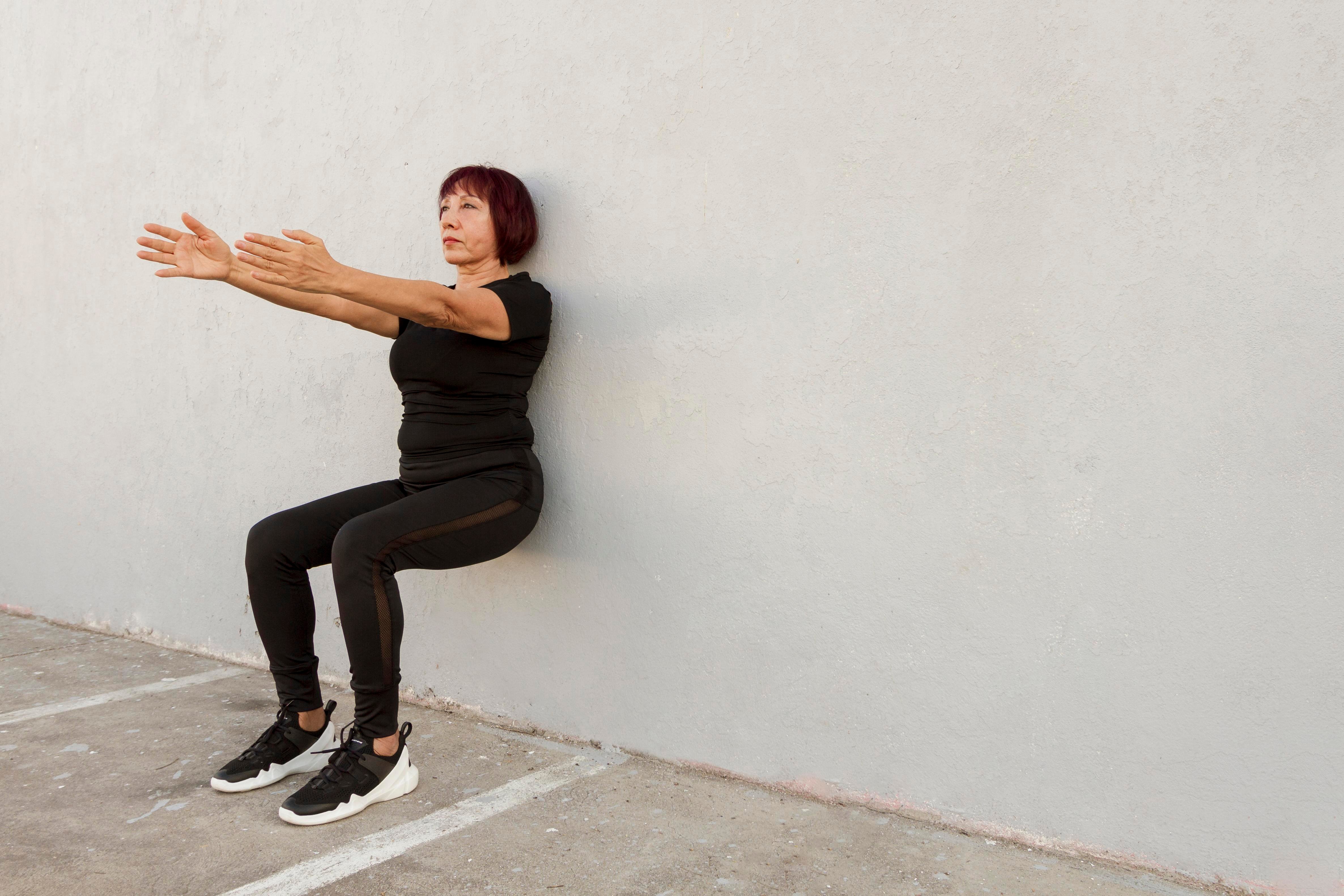 a-woman-doing-wall-squat-exercise to strengthen muscles.