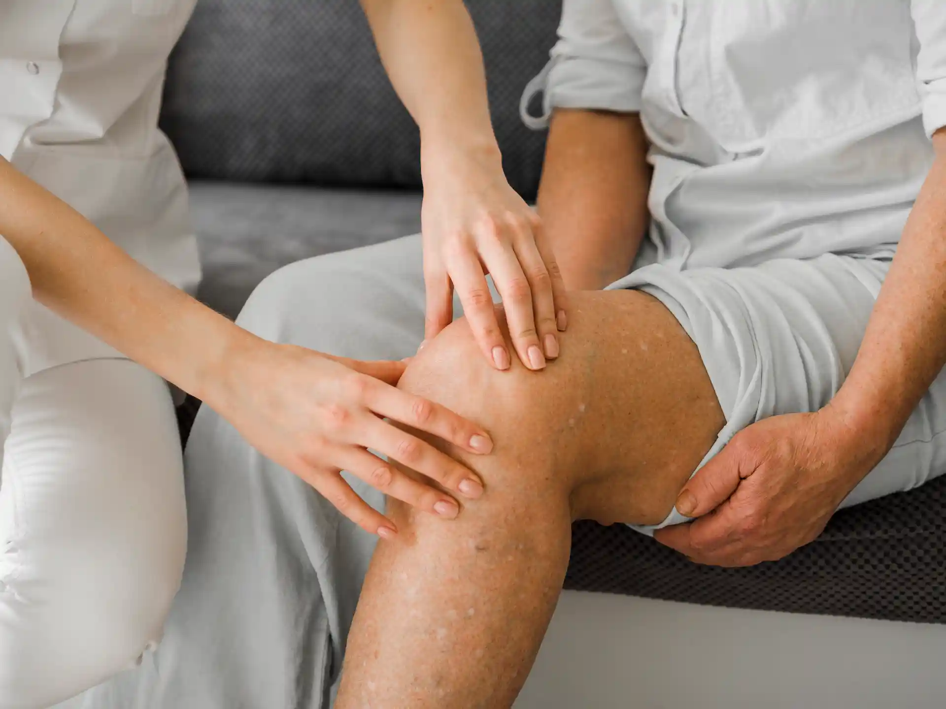 Doctor examining patient with osteoarthritis